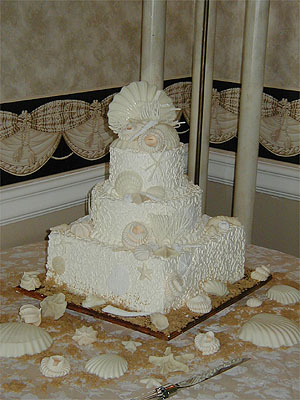 two layer round cake with square base and seashells