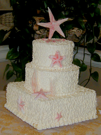 three layer wedding cake with pink starfish