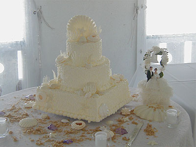 three layer cream colored shell themed wedding cake
