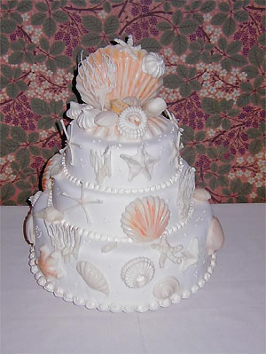 three layer white cake with sea stars and scallops