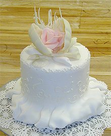 single layer wedding cake with scallop opening to reveal a rose