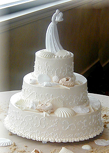 three layer wedding cake with seashell decorations