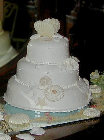 three layer pearlescent wedding cake with scallops and starfish details