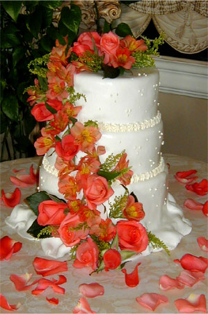 white cake with dark pink roses