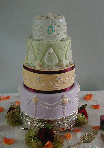 four layer multicolored cake with shells and cameo