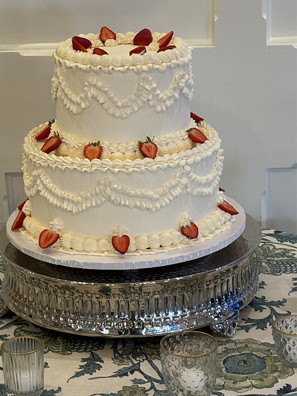 strawberry slices on a two tier ivory cake