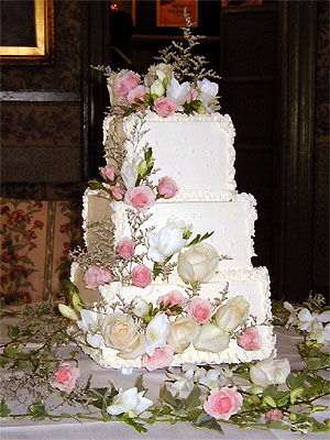 three layer pink and white rose cake