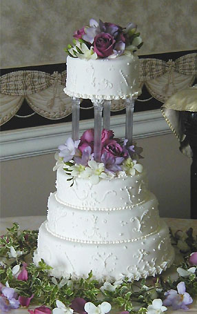 three tier cake with purple flowers