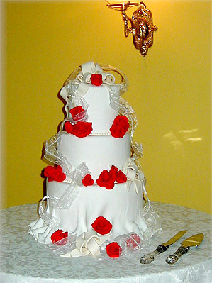 white cake with red roses
