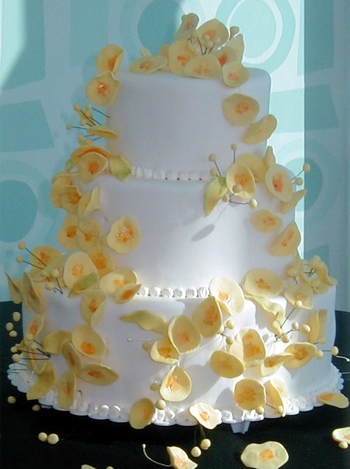 three layer cake with yellow flowers
