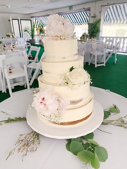 Rustic four layer round cake with pink peonies and white roses