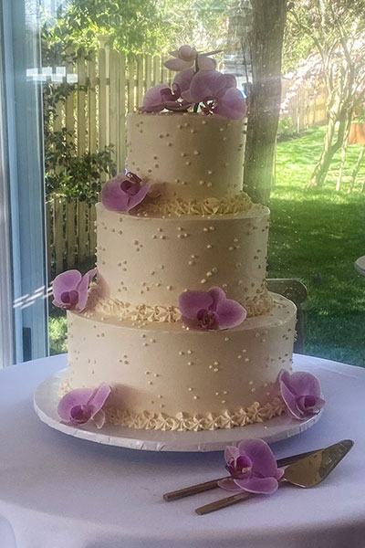 Ivory 3-tier cake with purple orchids