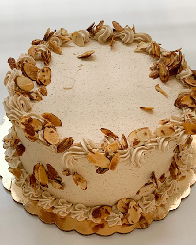 Round birthday cake with almonds