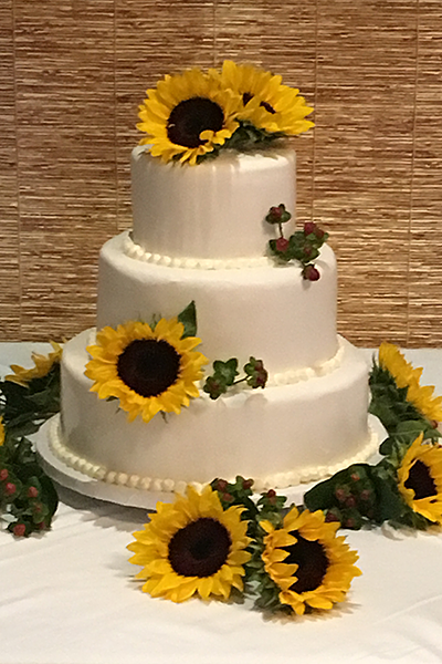 three layer round cake with sunflowers