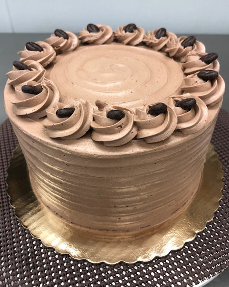 round cake with pale chocolate frosting